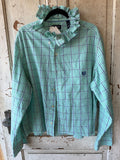 A mint green plaid long-sleeve button-up shirt with a ruffled collar, hanging on a black hanger against a rustic, weathered wooden door.